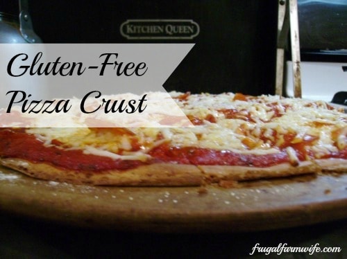 Image shows a gluten free pizza on a pizza stone topped with mozzerella and pepperoni. Text overlay reads "Gluten Free Pizza Crust"