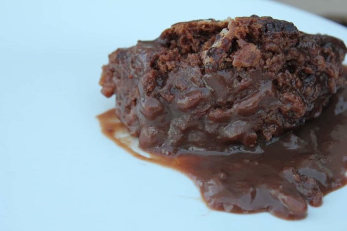 Photo shows a close up of gooey chocolate lava cake on a plate