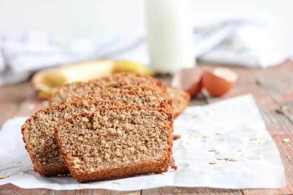 Image shows a few slices of banana bread sitting on a napkin on a table