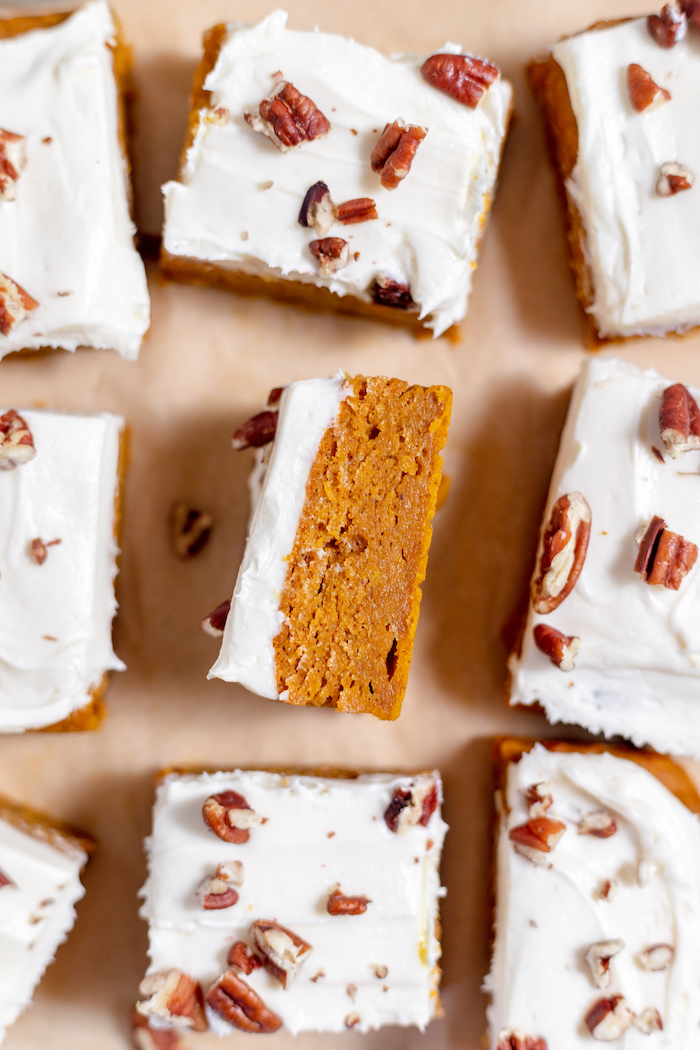pumpkin bars made with gluten free flour and cream cheese icing with pecans