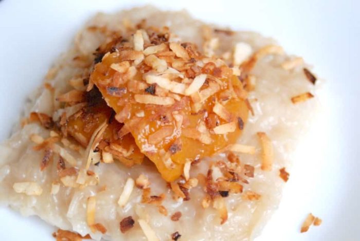 Image shows a close up of mango and coconut over sticky rice