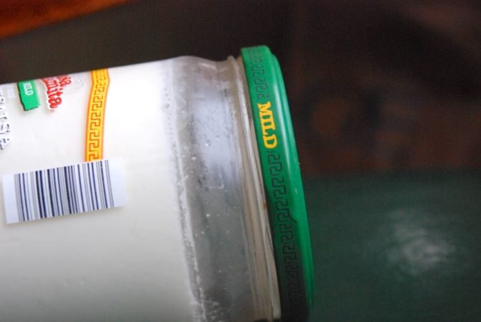 Image shows a jar of yogurt tipped on the side to illustrate it's thick enough