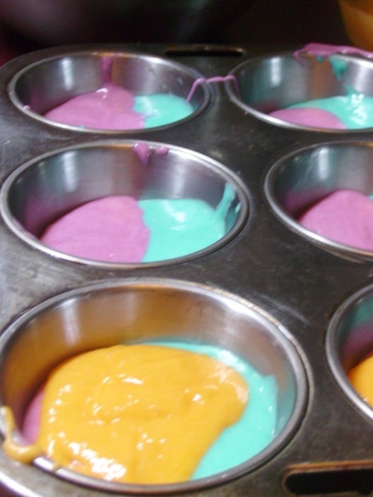 Photo shows additional colors of batter added to the cupcakes