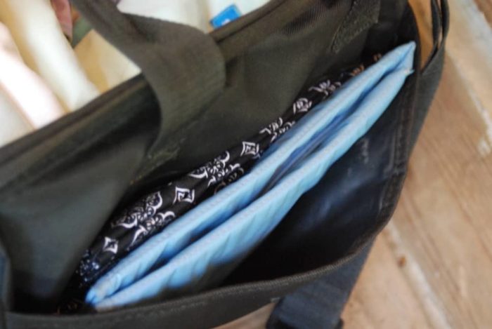 Photo shows changing pad in a side pocket of the diaper bag