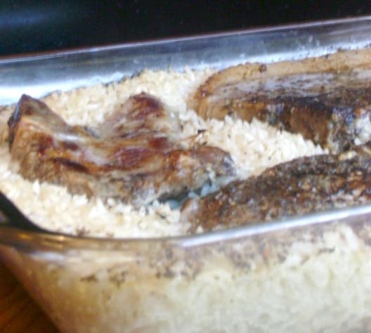 Image depicts pork chops and rice in a casserole dish