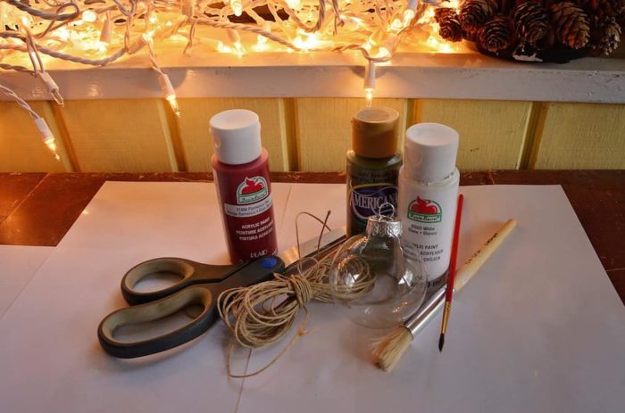 Image shows supplies needed for the ornament, paint, twine, brushes and scissors