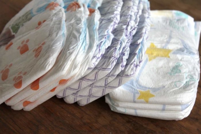 Photo shows several disposable diapers on a table