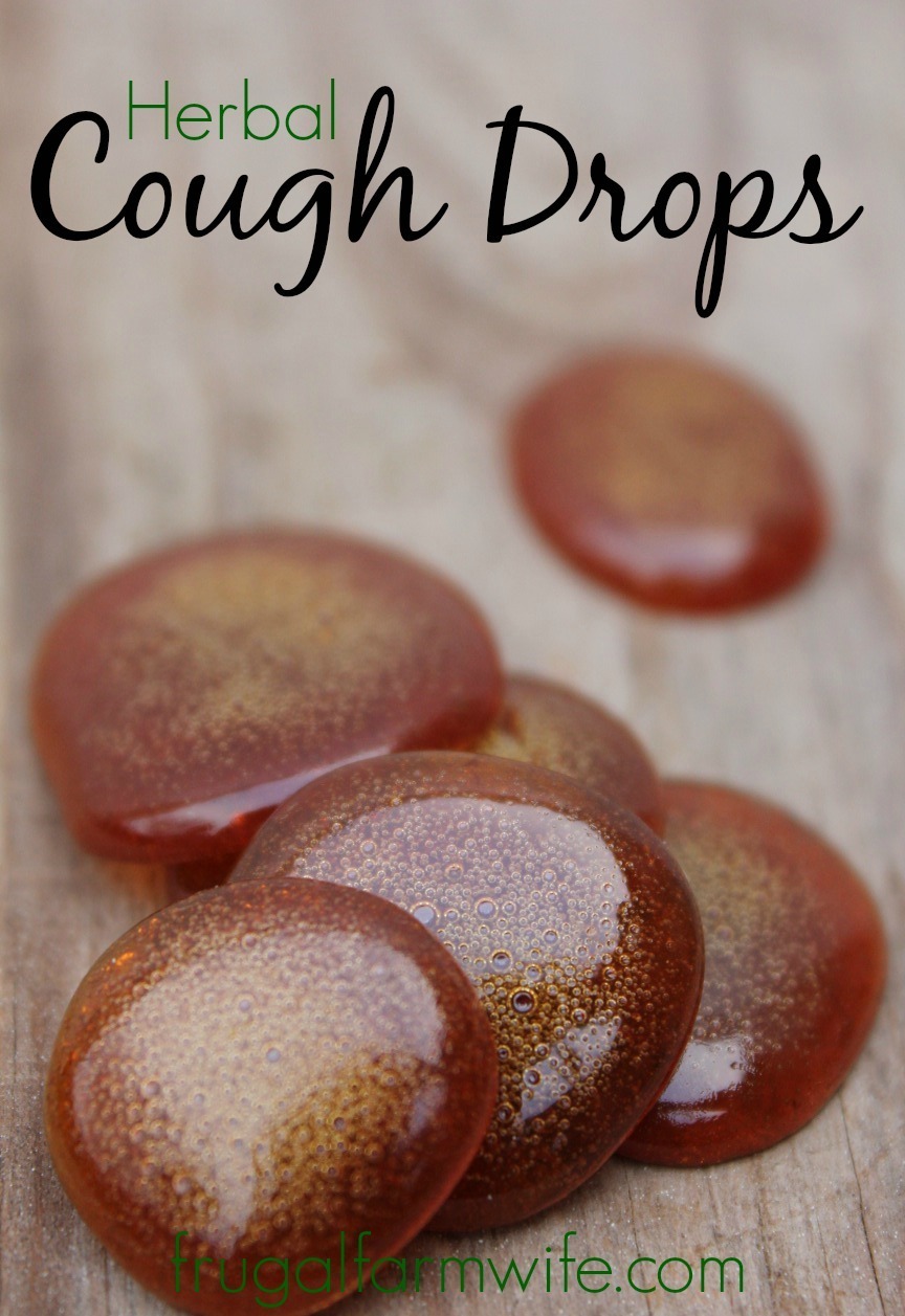 Photo shows several brown homemade cough drops taken very close up with text that reads "Herbal Cough Drops"