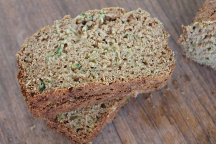 Photo shows two pieces of zucchini bread stacked on a table