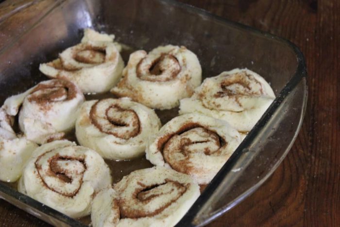 Photo shows gluten free cinnamon rolls in a baking dish