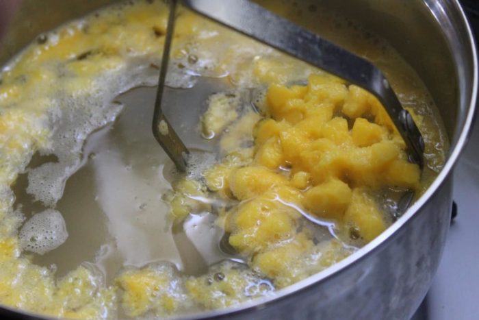 Image shows mango boiling in a large pot