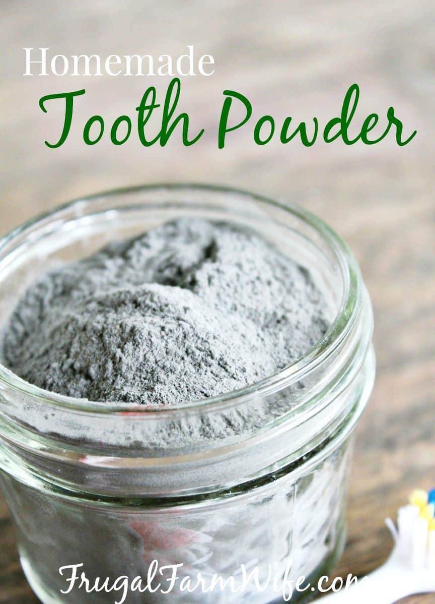 Image shows a close up of a small jar of grey powder, with text above that reads "Homemade Tooth Powder"