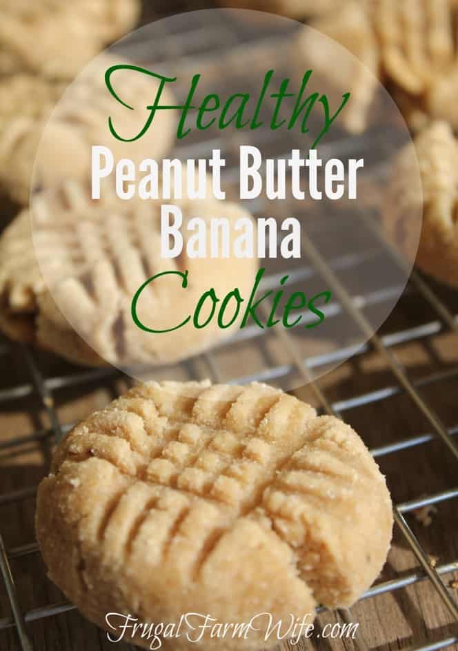 Image shows two enlarged cookies with fork crosshatching pressed into the top sitting on a wire cooling rack. Text reads "Healthy Peanut Butter Banana Cookies"