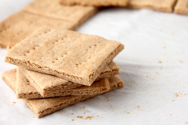 Photo shows a stack of homemade graham crackers on a white sheet