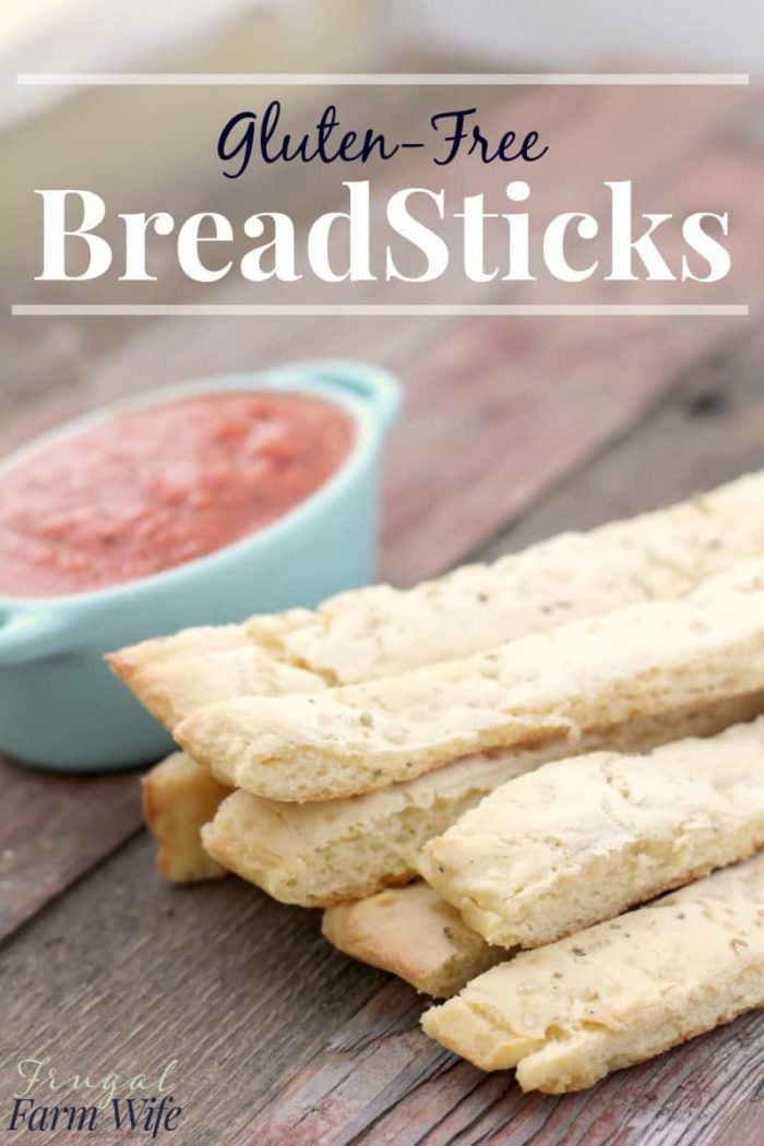 Image shows a stack of breadsticks next to a dish of marinara sauce with text that reads "Gluten-Free Breadsticks"