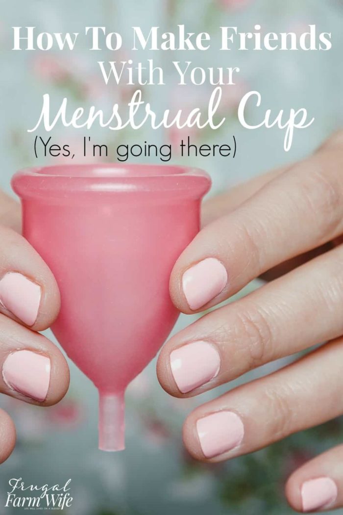 Image shows two hands holding a menstrual cup, with text that reads "How to Make Friends with your Menstrual Cup (Yes, I'm going there)"