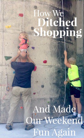 Image shows a man helping a small child climb a rock climbing wall, with text that reads "How we ditched shopping and made our weekend fun again"