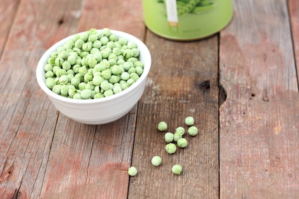Image shows a bowl of freeze dried peas on a table 