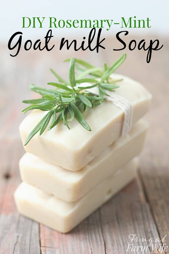 Image shows three bars of rosemary mint goat milk soap stacked on one another, tied with a string and a sprig of rosemary on top. Text overlay reads "Rosemary-Mint Goat Milk Soap"
