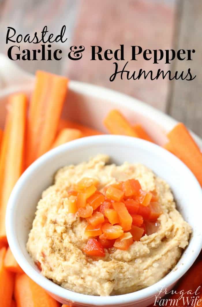 Image shows a plate of carrots with a bowl of hummus and text that reads "Roasted Garlic & Red Pepper Hummus"