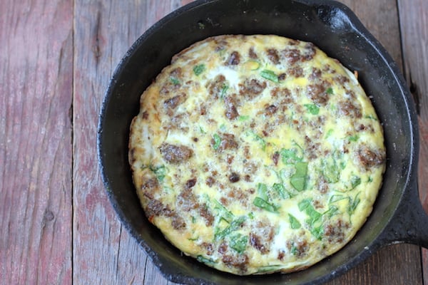 Photo shows an iron skillet with an egg and sausage frittata