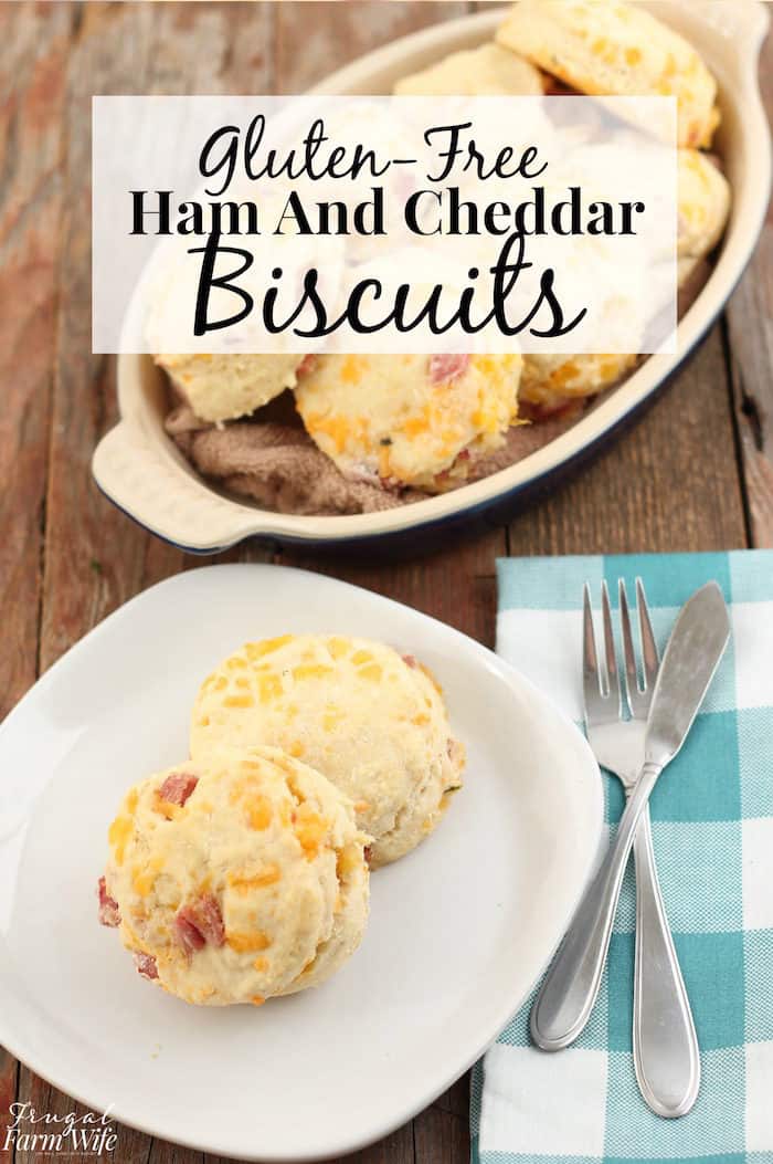 Image shows a plate with two ham and cheddar biscuits next to a bowl of them with text that reads "Gluten-Free Ham and Cheddar Biscuits"