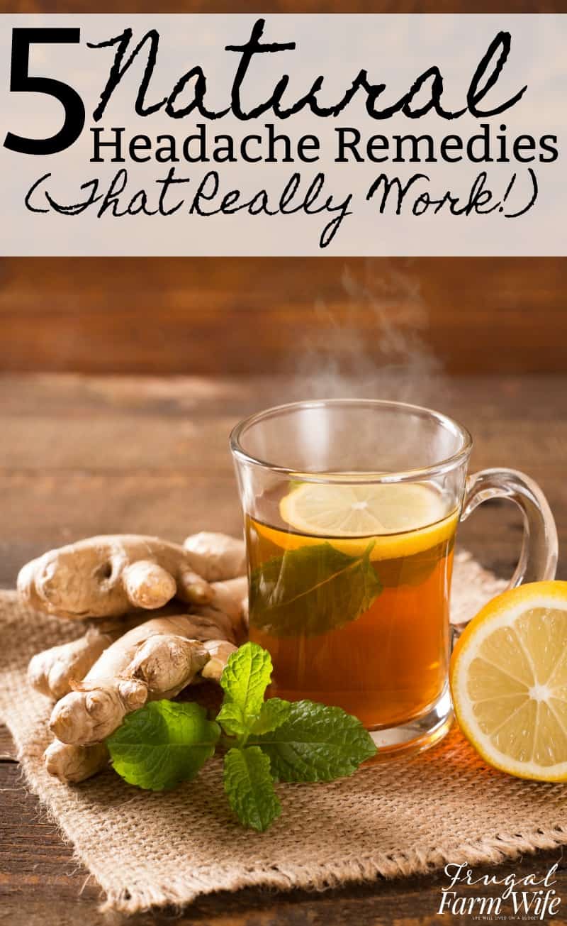 Image shows a clear mug of hot herbal tea sitting on a table. A slice of lemon and sprig of peppermint float in the mug. Nearby sits more peppermint, ginger root and a lemon. 