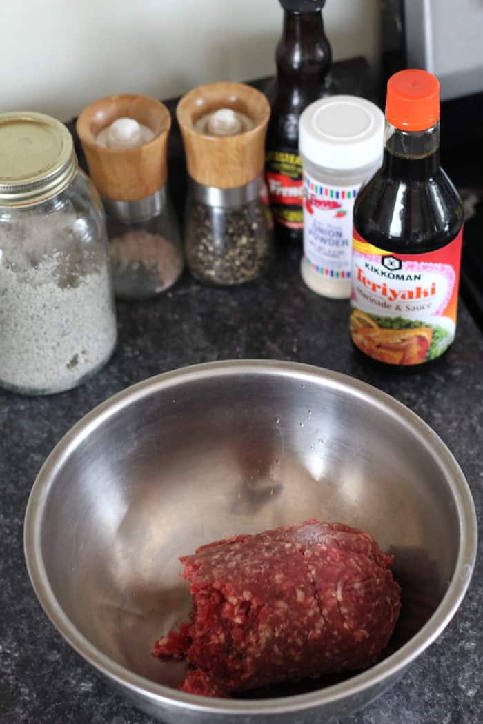 Image shows a bowl of ground beef along with all the ingredients needed to make jerky