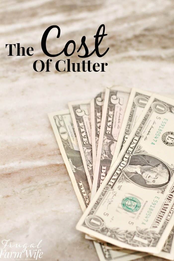 Image shows a pile of money on a counter with text that reads "The Cost of Clutter"