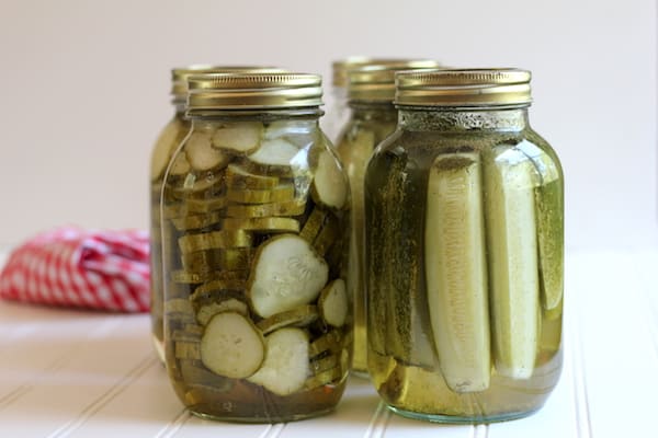Image shows several jars of homemade pickles on a table