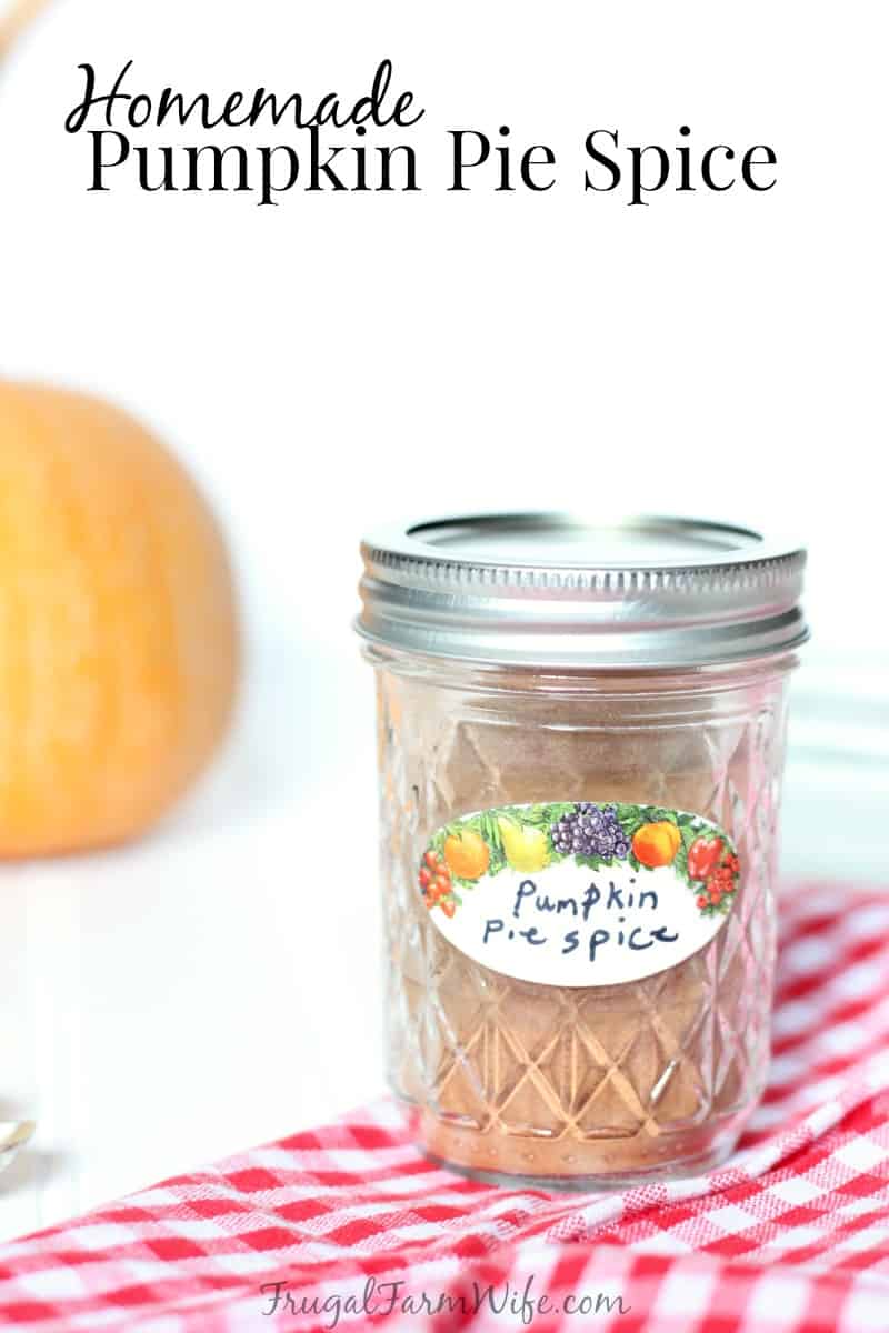 Image shows a small jar resting on a red and white napkin on a table with a label that reads "Pumpkin Pie Spice" Text overlay reads "Homemade Pumpkin Pie Spice"