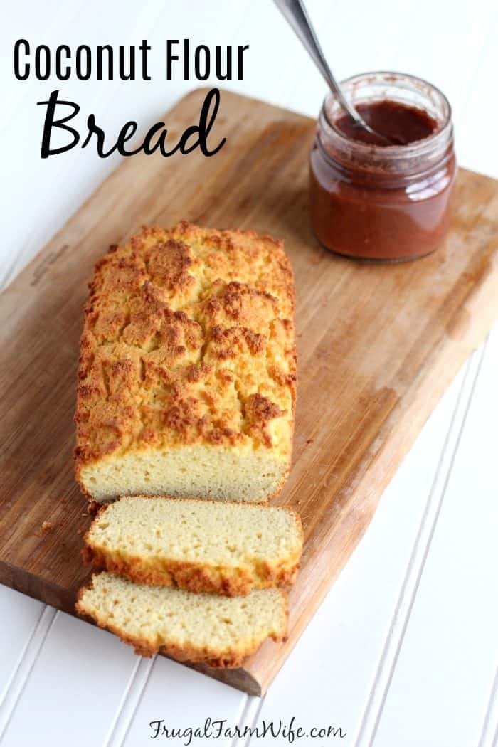 Photo shows a loaf of bread on a cutting board with text that reads "Coconut Flour Bread"