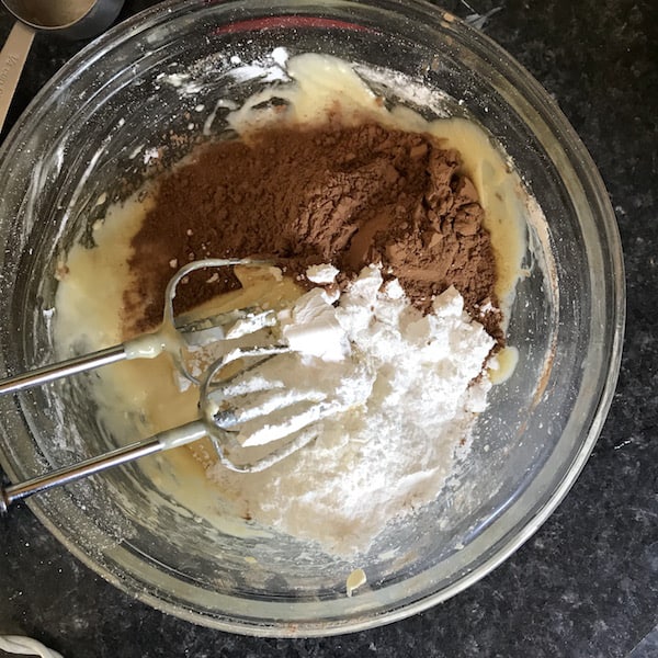 Photo shows a mixing bowl with ingredients for the gooey chocolate cake 