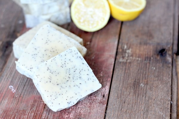 Image shows bars of lemon poppyseed soap on a table 
