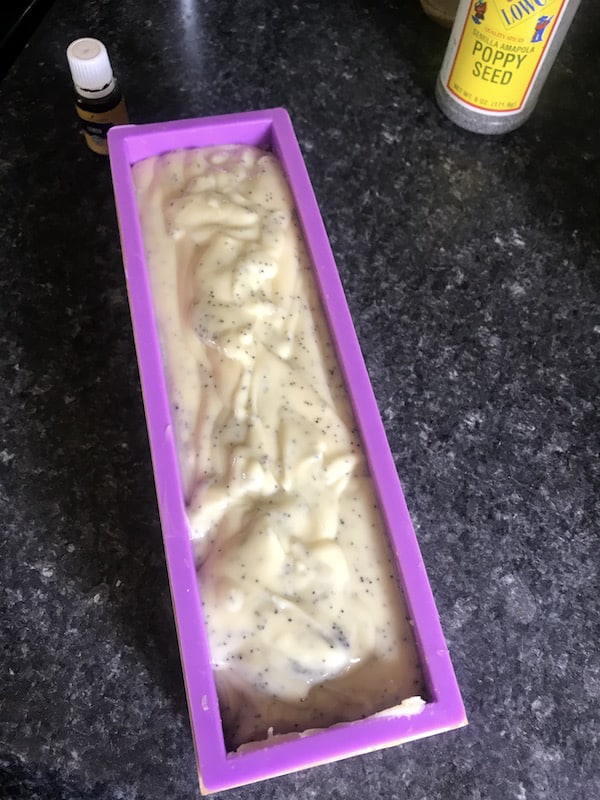 Image shows lemon poppyseed soap mix in mold