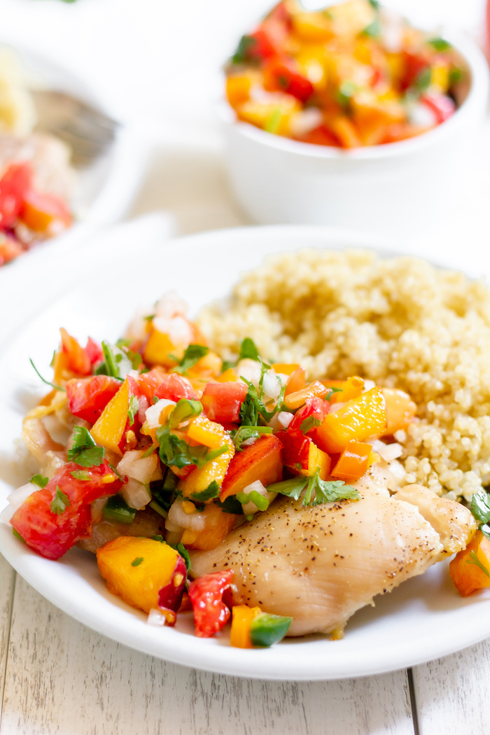 Images shows a plate of chicken with fresh peach salsa