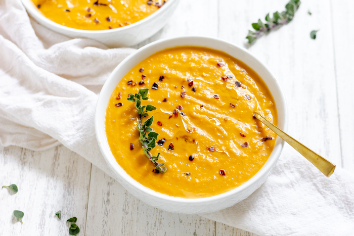 Image shows two bowls of butternut squash soup