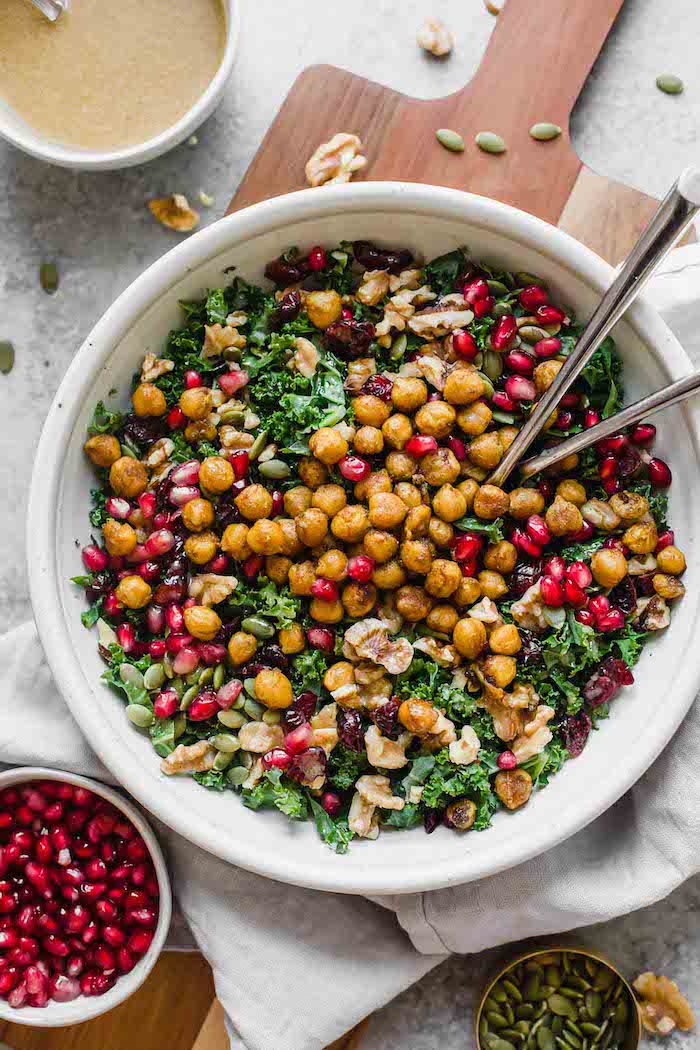 Photo shows a large bowl of chick pea salad with kale and cranberry