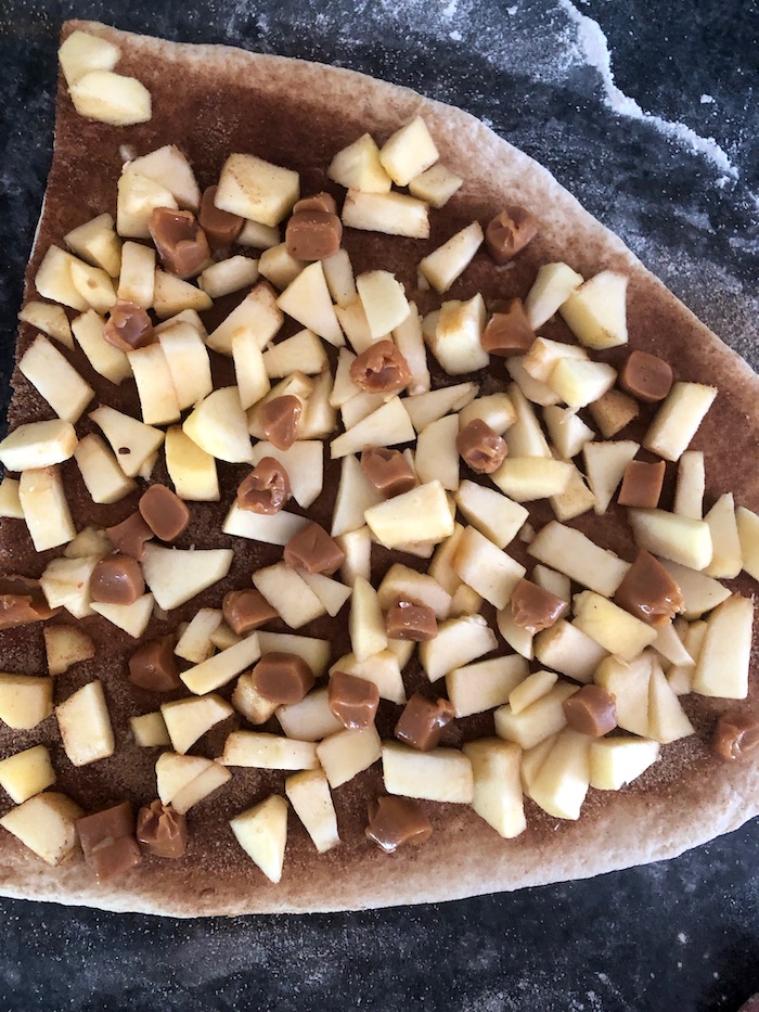 Photo shows layers of cinnamon, apples and dough