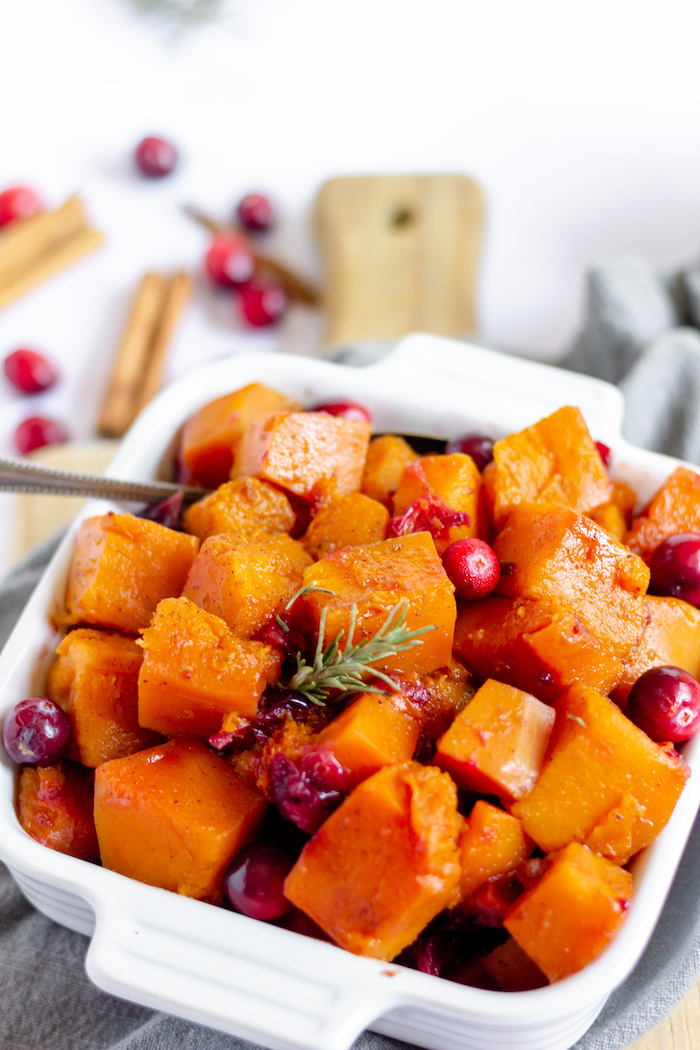 Photo shows a casserole dish of butternut squash and cranberry