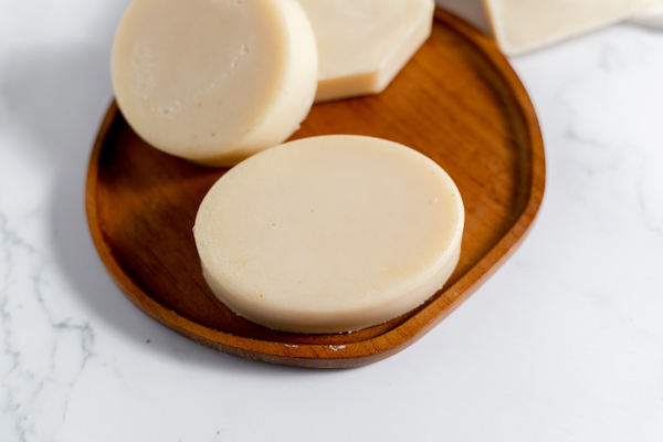finished goat milk soap resting on a plate