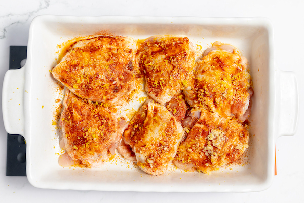seasoned chicken thighs with spices, butter, galric, and lemon zest