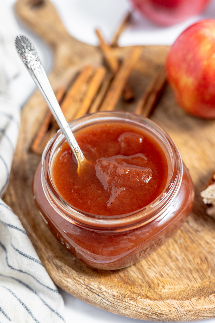 jar of apple butter with a serving knife