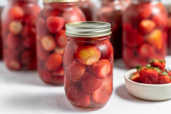 pint jars with a bowl of fruit